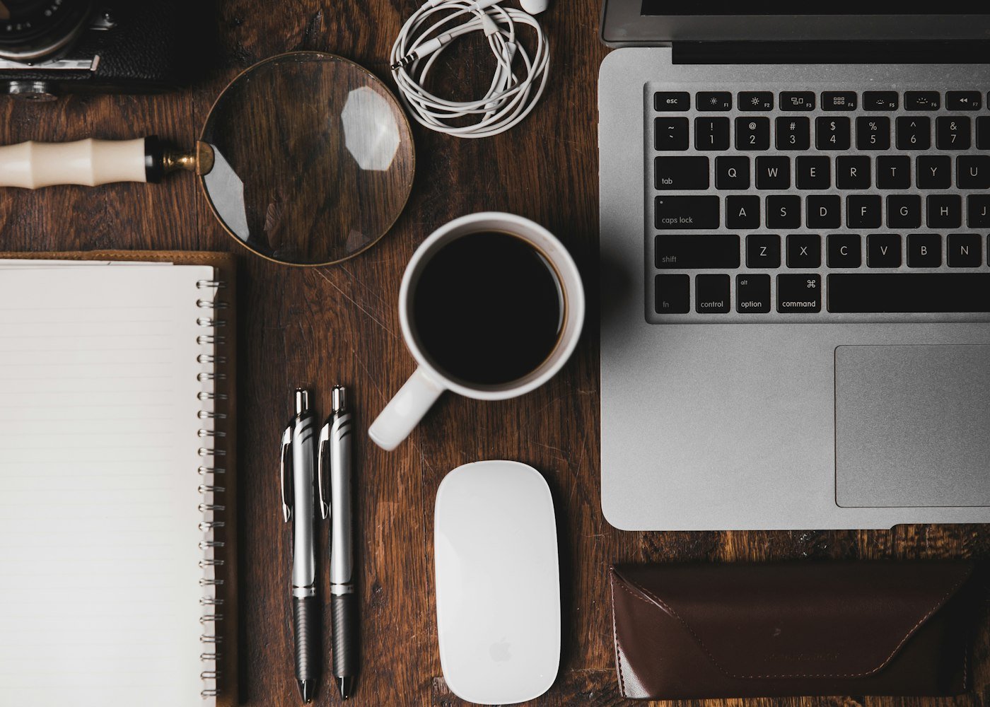 A laptop and a cup of coffee on a small desk, representing Marketivv's scrappy 2019 founding in Kolkata